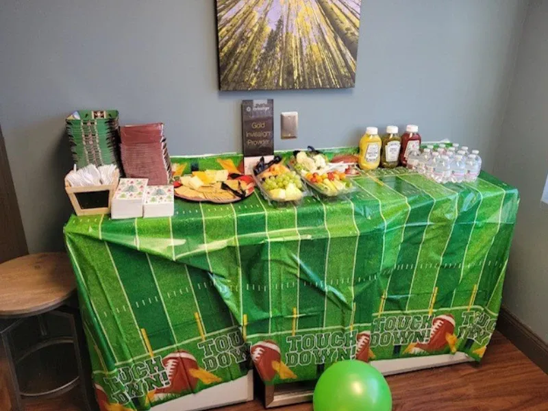 Photo of a Table with Football Decorations and Snacks