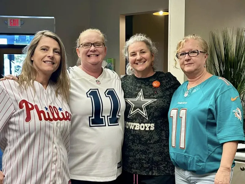 Photo of 4 People in Athletic Sports Jerseys