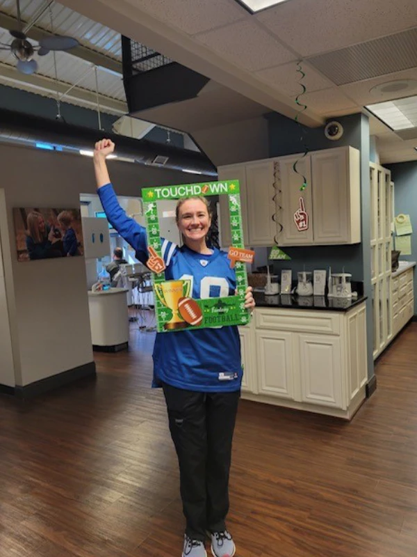 Photo of Dental Staff Member Posing with a Football Cutout