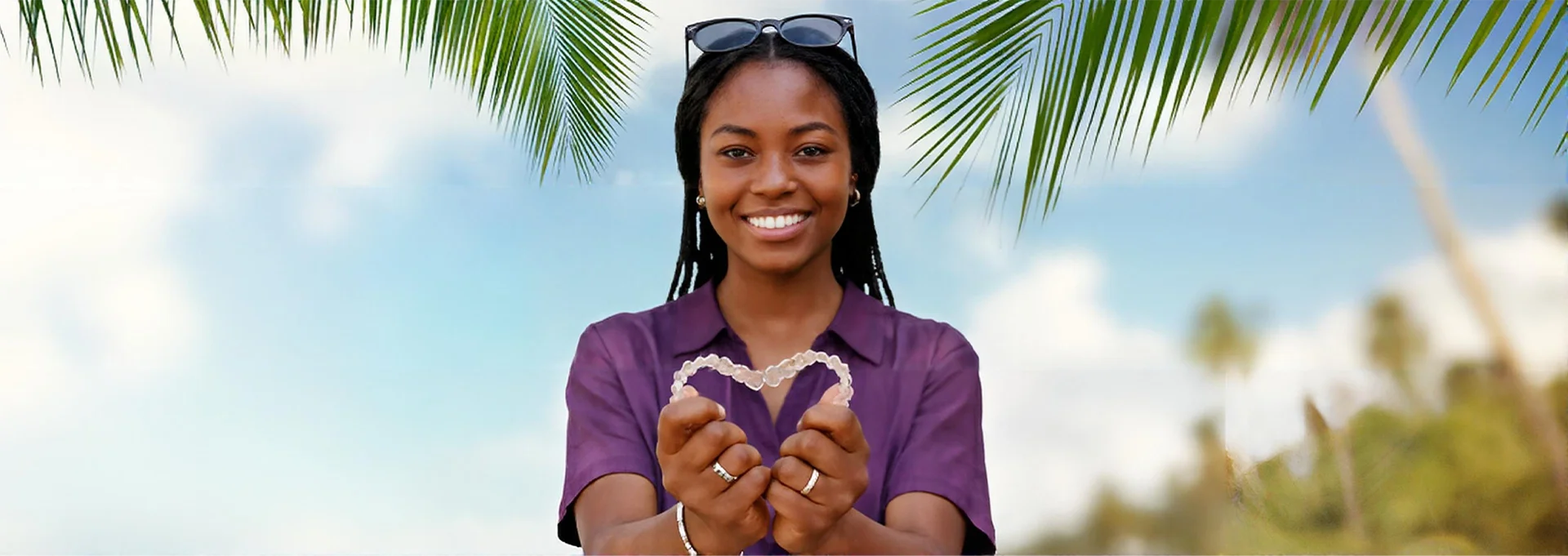 Person making a heart using Invisalign Clear Braces