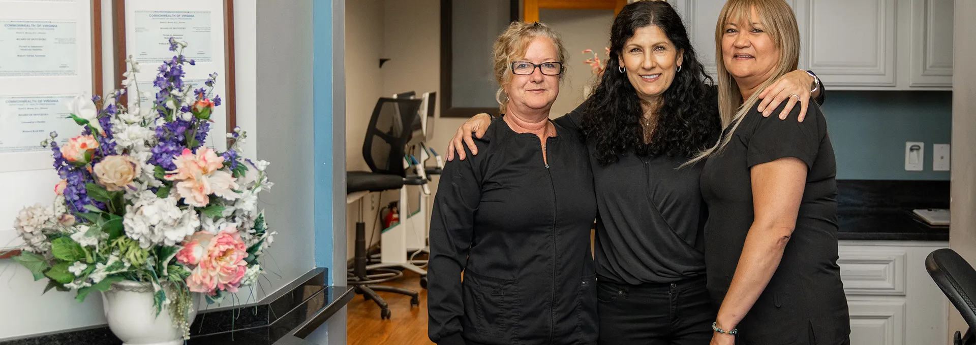 3 Dental Staff Members Smiling at the Camera in a Dental Office