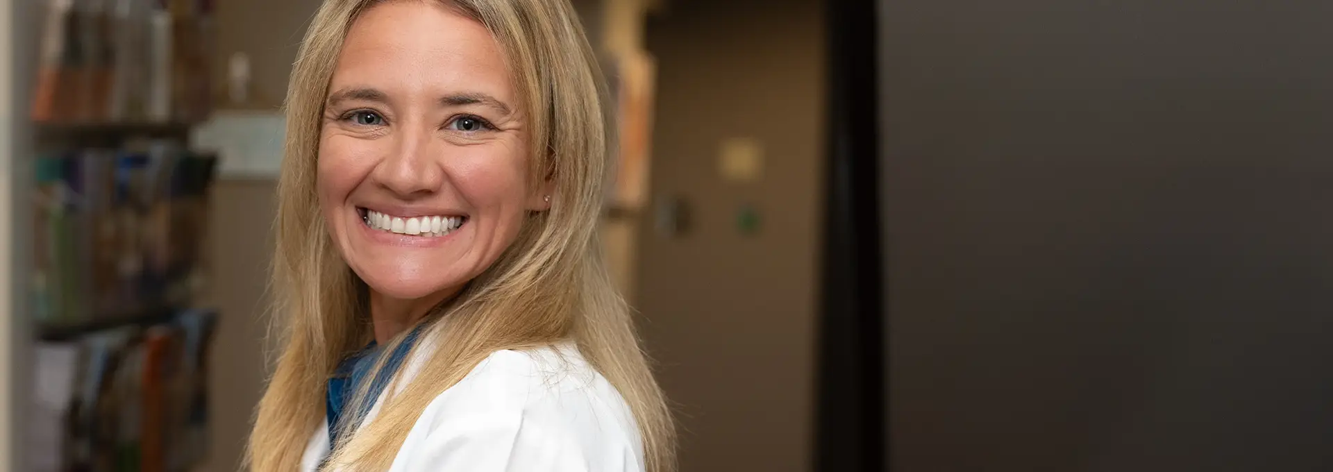 Closeup of Dr. Nikki Sparks, DDS standing in office smiling