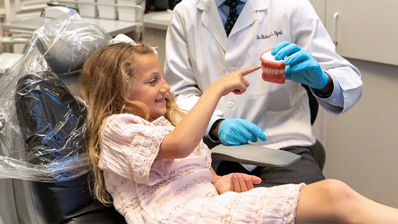 dentist sharing prevention tactics with pediatric patient